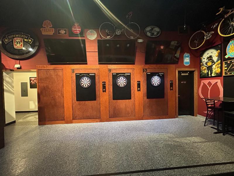 Dartboard bays 8, 9 and 10 set into an oak divider wall.